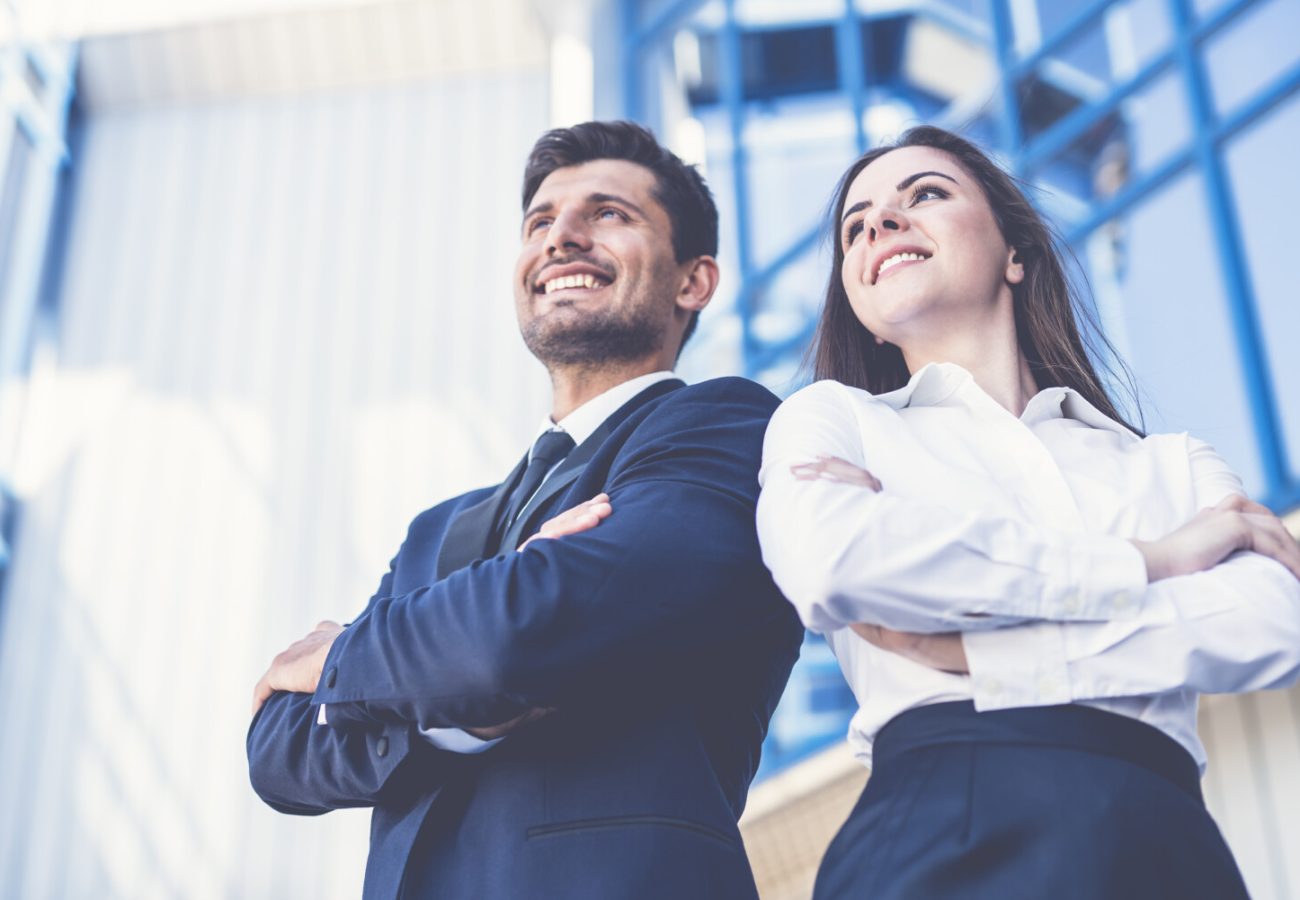 The smile man and woman stand on the background of the office center