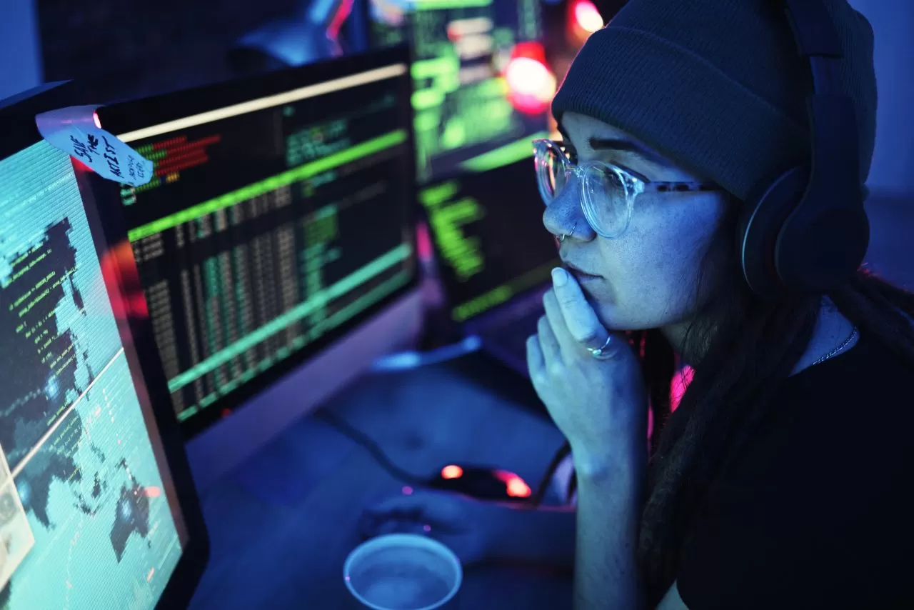 woman-computer-and-hacker-with-music-headphones-and-programming-for-cybersecurity-thinking-radio-e1698778386759.jpg